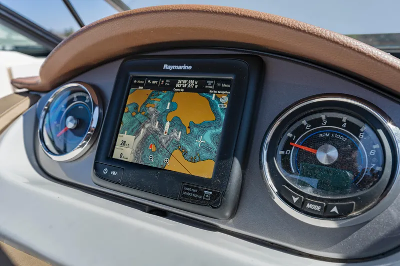 Slide: The Image of Dashboard of 2017 Sea Ray SDX 270 Outboard with navigation display and gauges. - 18