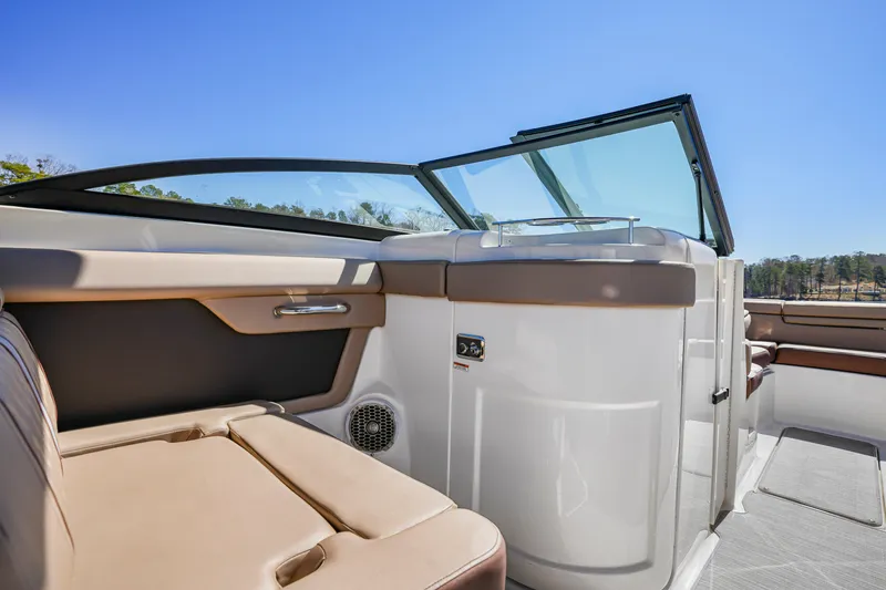 Slide: The Image of 2017 Sea Ray SDX 270 Outboard interior with tan seating and sleek design. - 8
