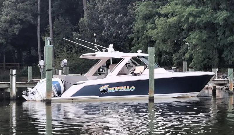 Slide: The Image of 2019 Tiara Sport 38 LS boat docked by trees and water. - 1