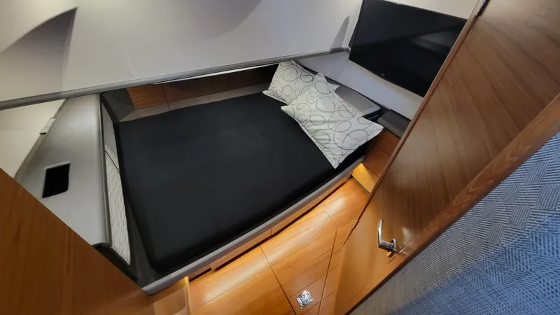 Slide: The Image of 2019 Tiara Sport 38 LS cabin interior with bed and pillows. - 11
