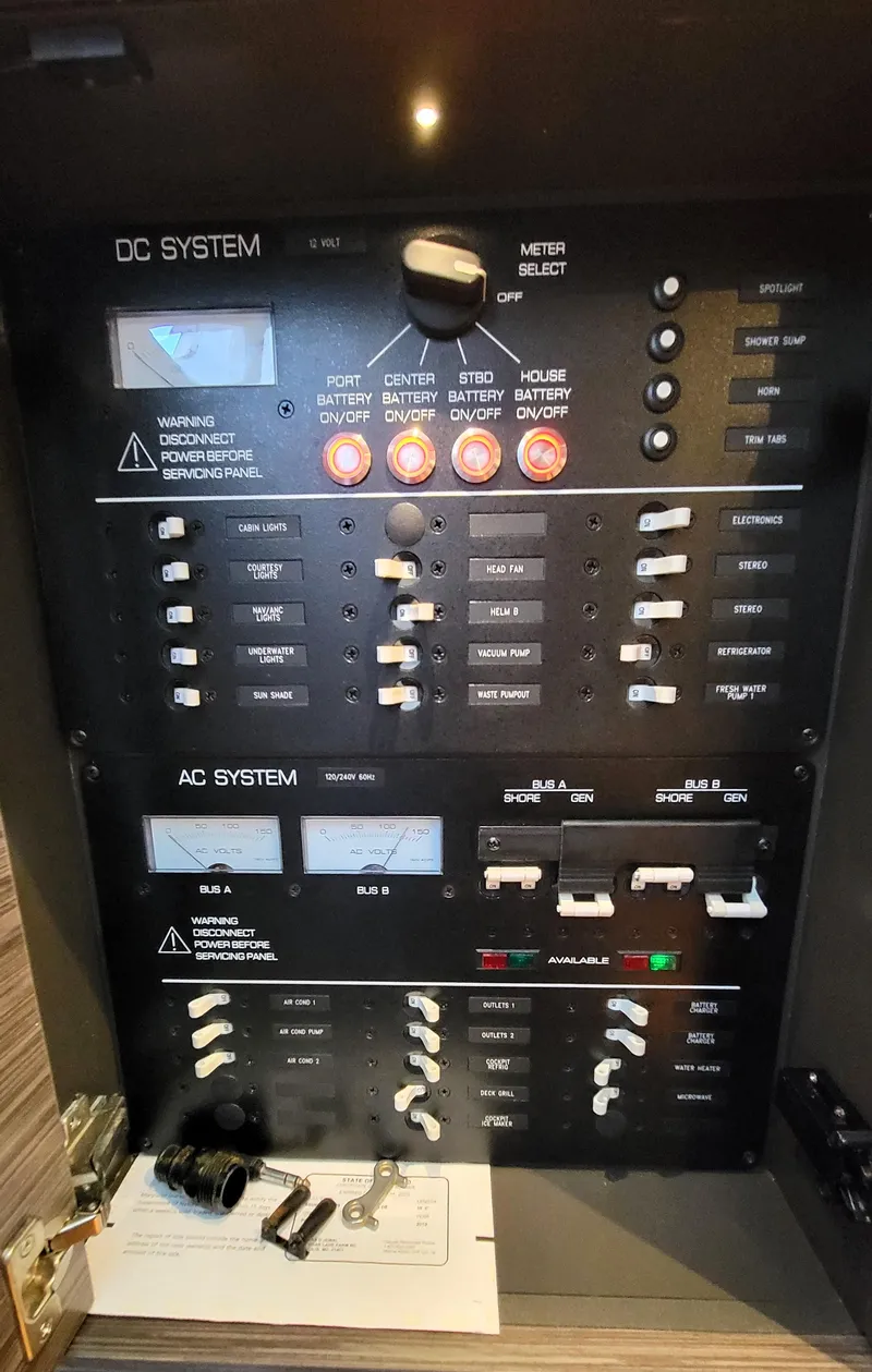 Slide: The Image of Control panel of a 2019 Tiara Sport 38 LS boat, featuring DC and AC systems. - 14