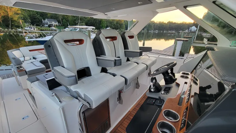 Slide: The Image of Luxurious 2019 Tiara Sport 38 LS yacht interior with plush seating and modern helm. - 7