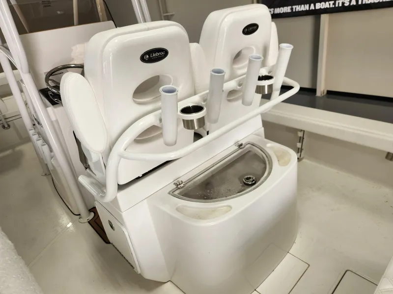 Slide: The Image of 2025 BlackJack 256 Coastal boat seating with integrated rod holders and storage compartment. - 10