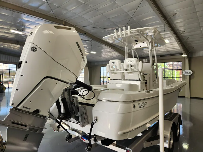 Slide: The Image of 2025 BlackJack 256 Coastal boat with powerful outboard motor in showroom. - 4