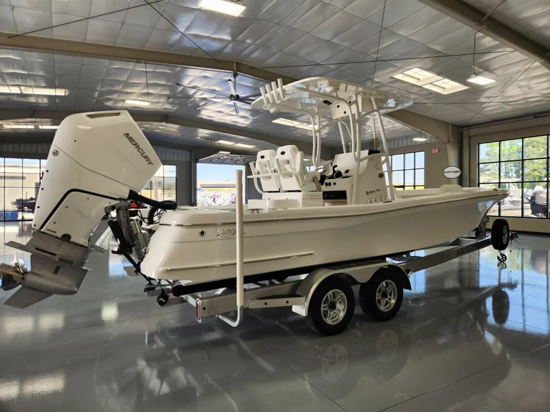 Slide: The Image of 2025 BlackJack 256 Coastal boat on trailer in showroom with Mercury outboard engine. - 5