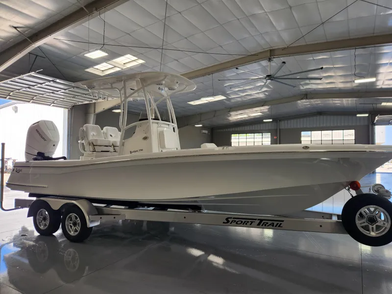 Slide: The Image of 2025 BlackJack 256 Coastal boat on Sport Trail trailer in a spacious indoor facility. - 6