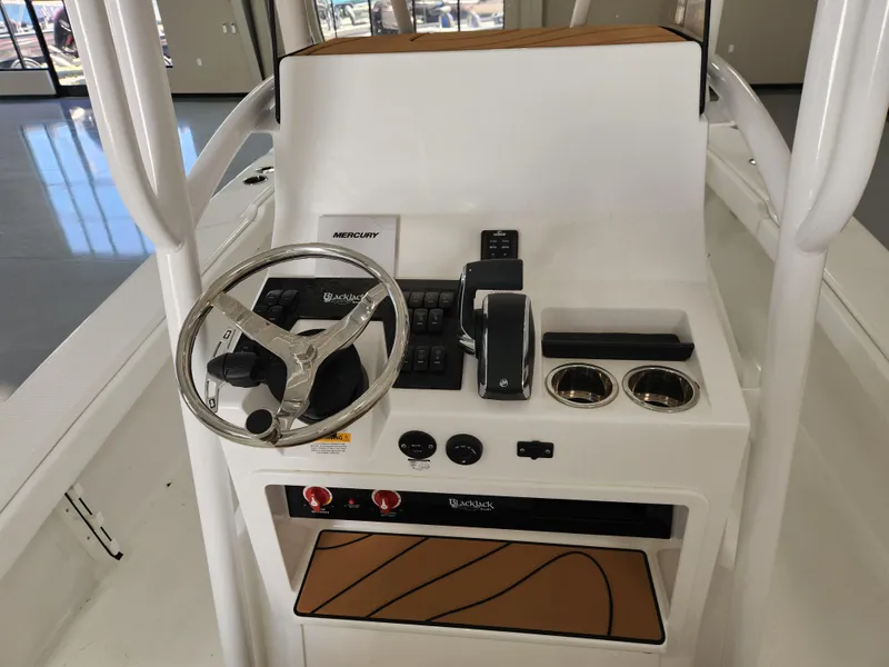 Slide: The Image of 2025 BlackJack 256 Coastal boat console with steering wheel and controls. - 8