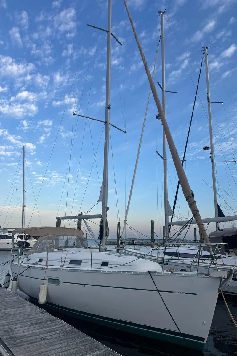 The Image of 2001 Beneteau 361 sailboat docked under a blue sky with scattered clouds. - 0