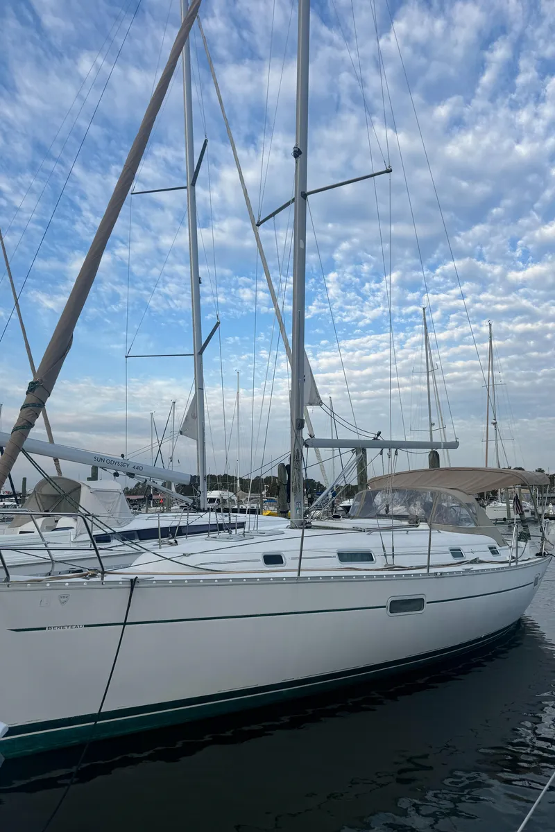 Slide: The Image of 2001 Beneteau 361 sailboat docked under a partly cloudy sky. - 1