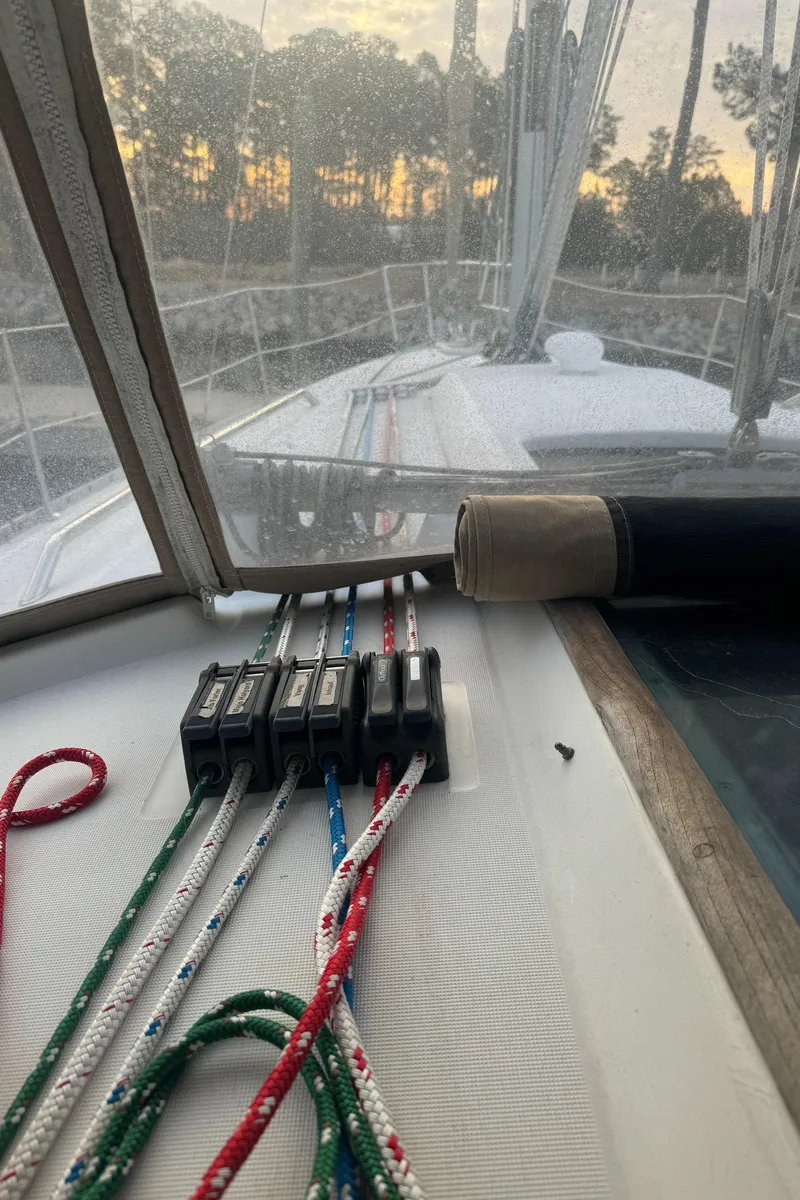 Slide: The Image of 2001 Beneteau 361 sailboat deck with ropes and winches at sunset. - 13