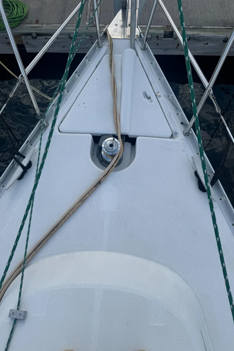 Slide: The Image of Bow of 2001 Beneteau 361 sailboat with deck fittings and mooring lines. - 14
