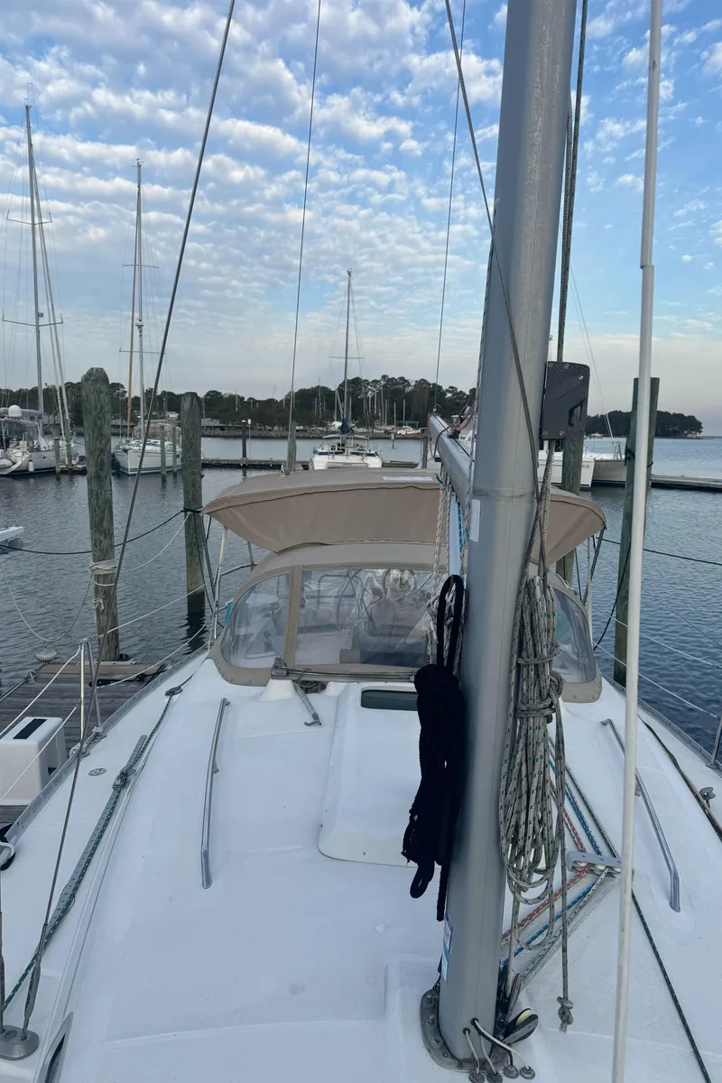 Slide: The Image of 2001 Beneteau 361 sailboat docked at marina under a partly cloudy sky. - 15