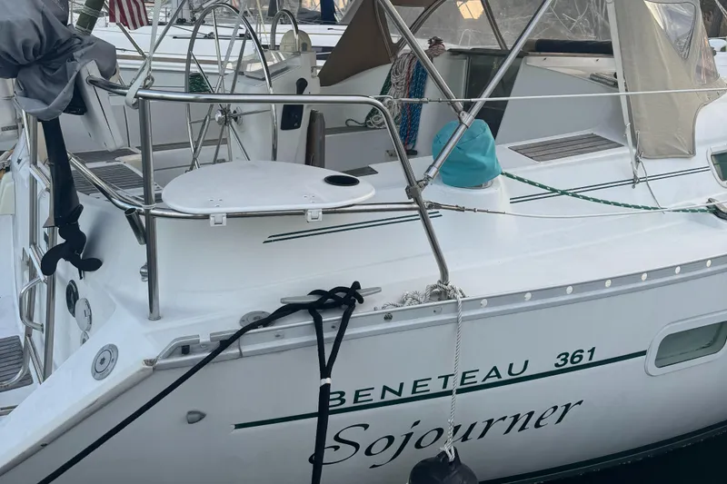 Slide: The Image of 2001 Beneteau 361 sailboat named Sojourner docked at a marina. - 2