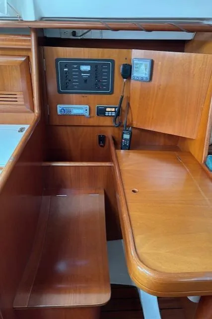 Slide: The Image of 2001 Beneteau 361 yacht interior with navigation panel and wooden desk. - 26