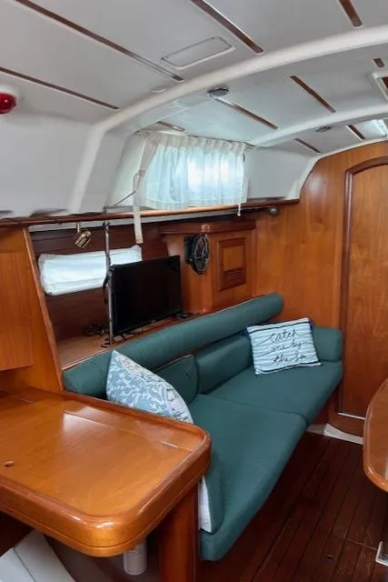 Slide: The Image of Interior of 2001 Beneteau 361 sailboat with cozy seating and wooden finishes. - 29
