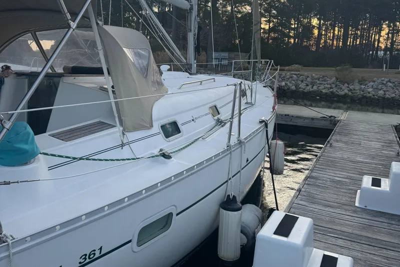 Slide: The Image of 2001 Beneteau 361 sailboat docked at marina with forest backdrop. - 3