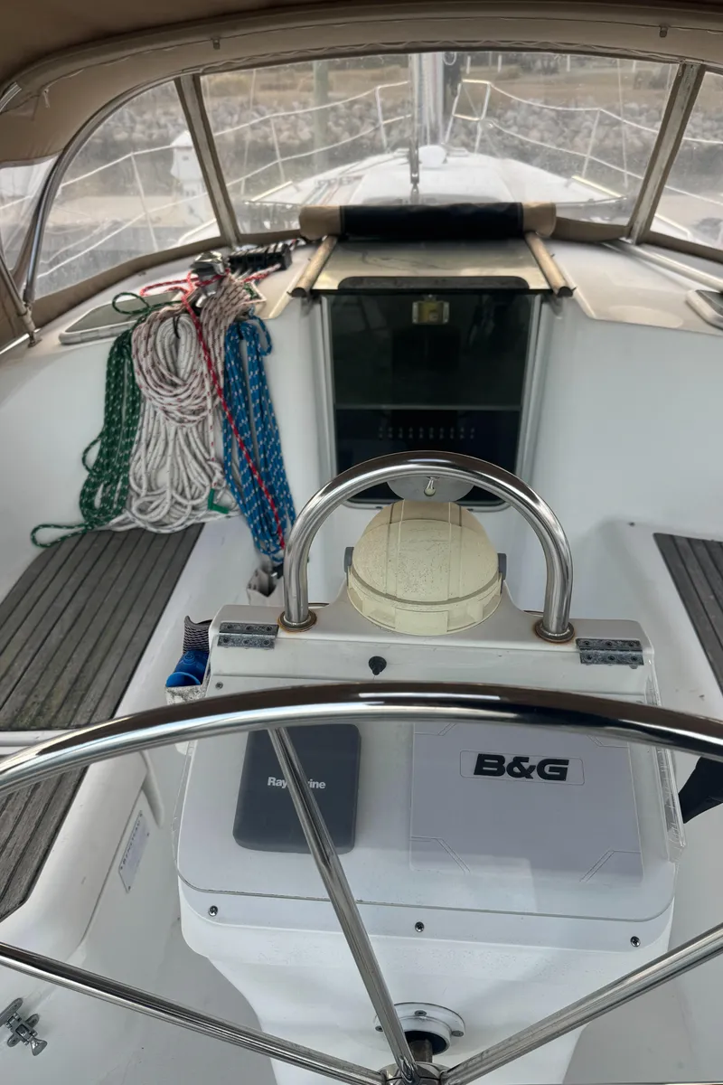 Slide: The Image of Beneteau 361 sailboat cockpit with steering wheel, ropes, and navigation equipment, 2001 model. - 4