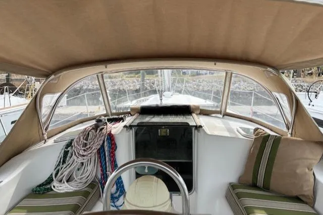 Slide: The Image of 2001 Beneteau 361 sailboat cockpit with canopy, ropes, and striped cushions. - 5