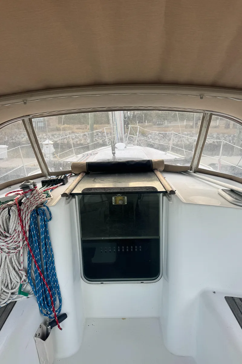 Slide: The Image of 2001 Beneteau 361 sailboat cockpit with ropes and covered hatch. - 7