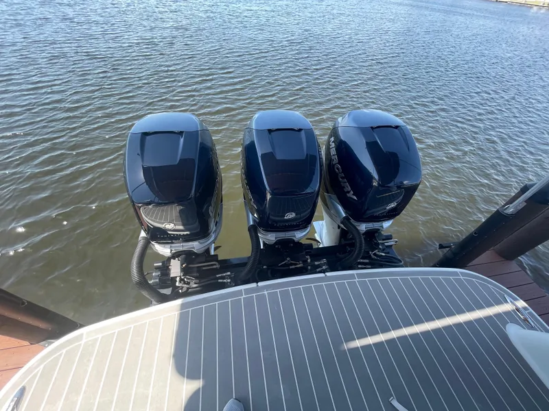 Slide: The Image of 2020 Formula 350 Crossover Bowrider OB with triple outboard engines on water. - 10