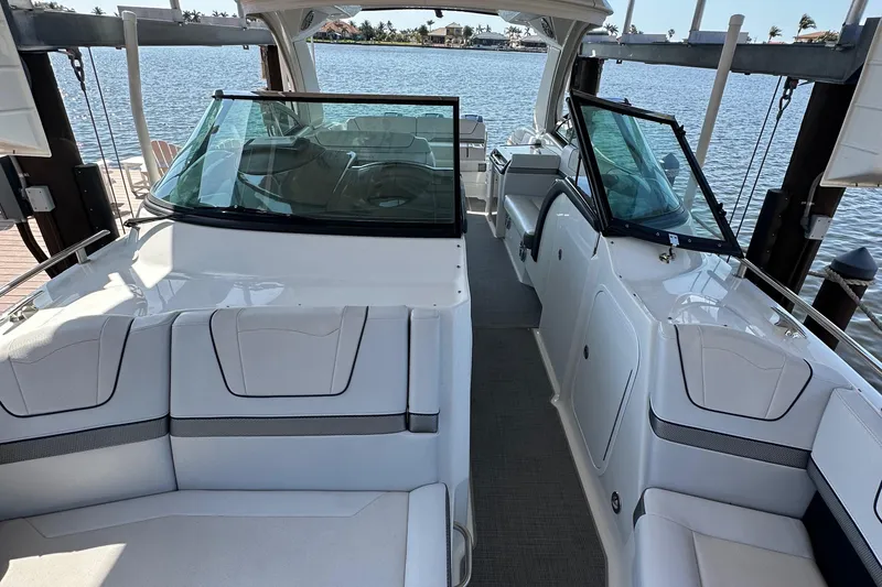 Slide: The Image of 2020 Formula 350 Crossover Bowrider OB, spacious interior, docked by the water. - 15