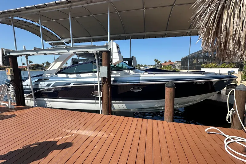 Slide: The Image of 2020 Formula 350 Crossover Bowrider OB docked under a canopy. - 2