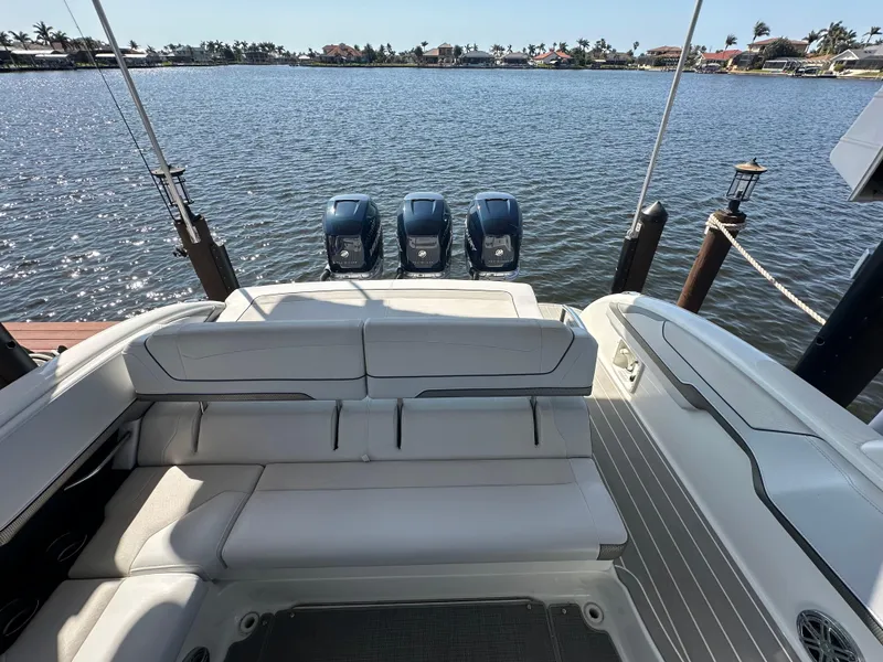 Slide: The Image of 2020 Formula 350 Crossover Bowrider OB with triple outboard engines on a serene lake. - 24