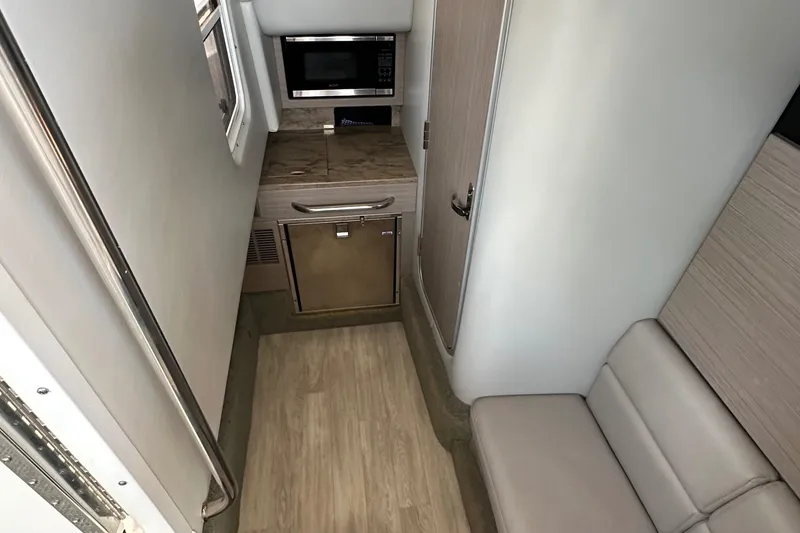 Slide: The Image of 2020 Formula 350 Crossover Bowrider OB interior with kitchenette and seating area. - 29