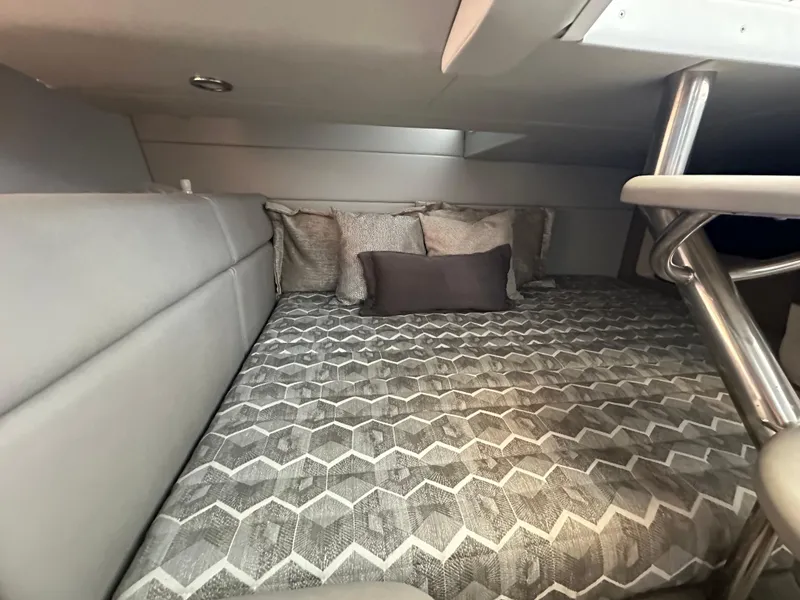 Slide: The Image of 2020 Formula 350 Crossover Bowrider OB cabin interior with patterned bedding and cushions. - 31