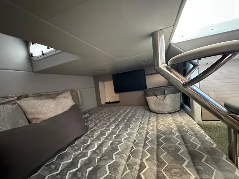 Slide: The Image of 2020 Formula 350 Crossover Bowrider OB cabin interior with bed and TV. - 32
