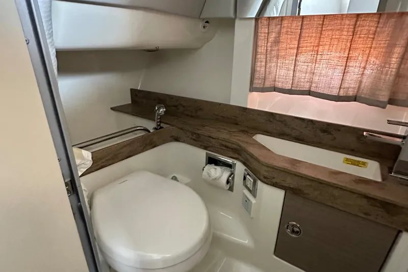 Slide: The Image of 2020 Formula 350 Crossover Bowrider OB bathroom interior with modern fixtures and wood accents. - 33