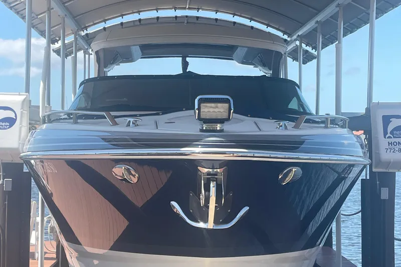 Slide: The Image of 2020 Formula 350 Crossover Bowrider OB docked under a canopy. - 5