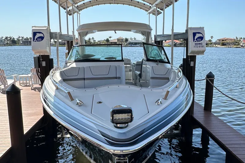 Slide: The Image of 2020 Formula 350 Crossover Bowrider OB docked on a sunny waterfront. - 6