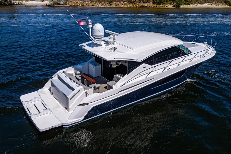 Slide: The Image of 2020 Tiara Yachts C53 Coupe cruising on open water, showcasing sleek design and luxury features. - 1