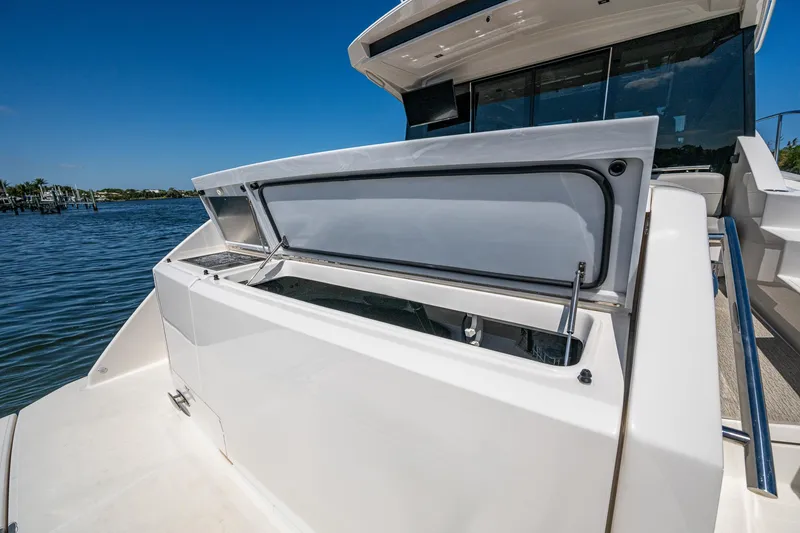 Slide: The Image of 2020 Tiara Yachts C53 Coupe, open deck compartment, sunny day, waterfront view. - 11