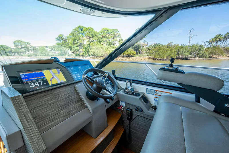 Slide: The Image of 2020 Tiara Yachts C53 Coupe helm with modern navigation system and luxurious interior. - 16