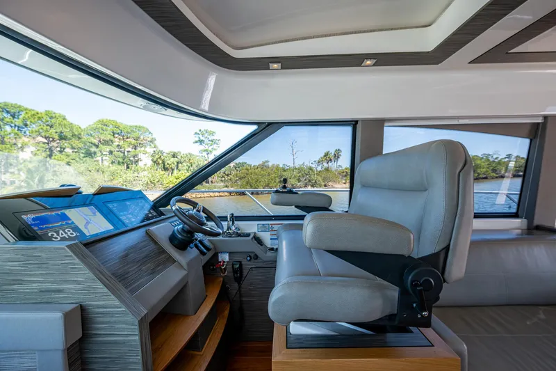 Slide: The Image of Interior of 2020 Tiara Yachts C53 Coupe, featuring modern helm and luxurious seating. - 17