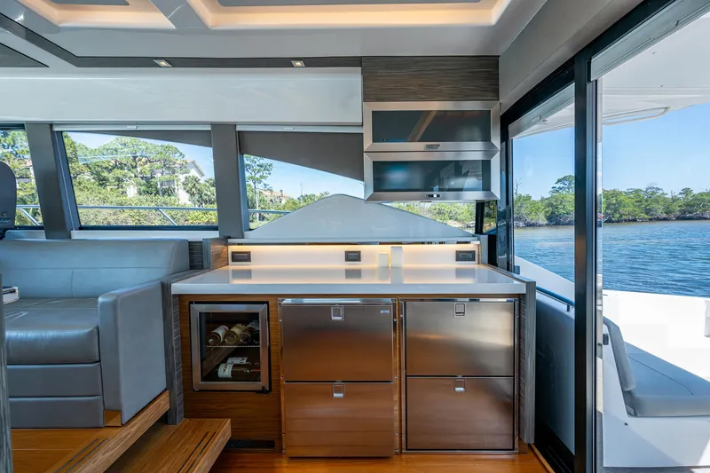 Slide: The Image of Interior of 2020 Tiara Yachts C53 Coupe, featuring modern kitchen and scenic water view. - 21