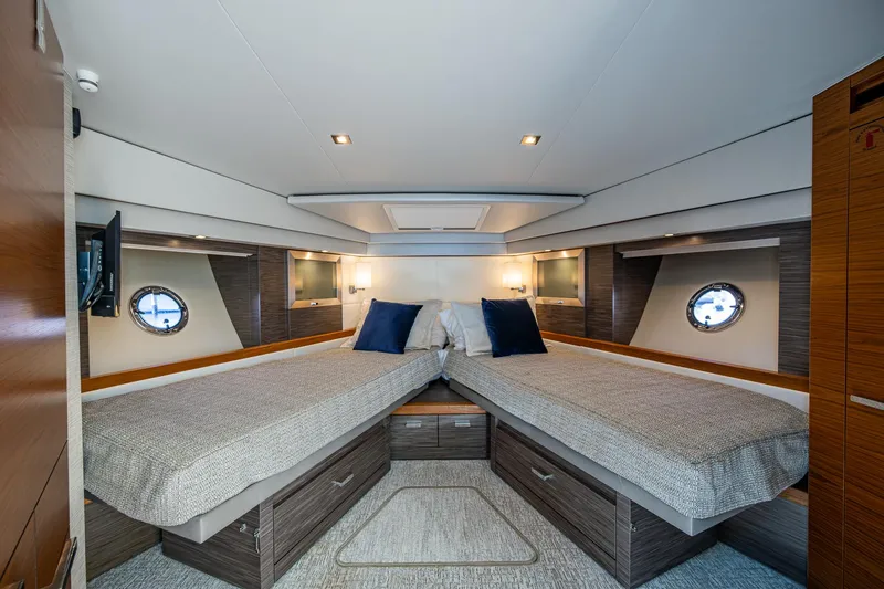 Slide: The Image of Luxurious 2020 Tiara Yachts C53 Coupe cabin with twin beds and modern decor. - 25