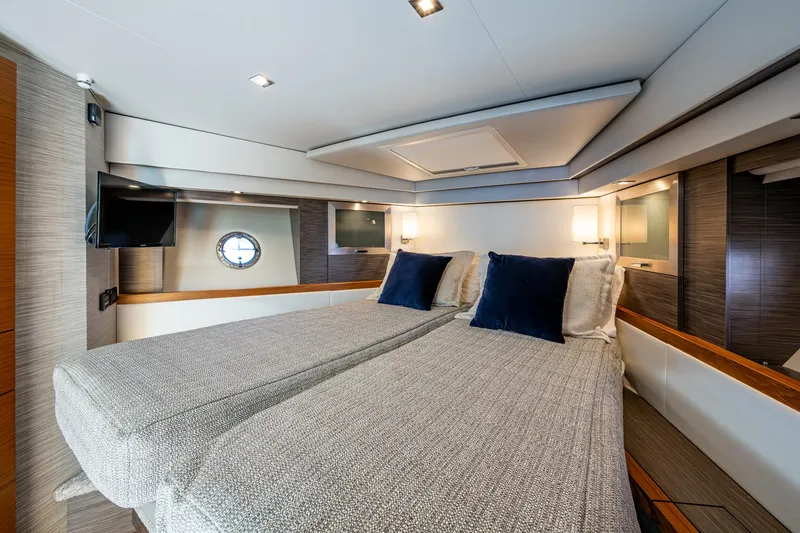 Slide: The Image of Luxurious 2020 Tiara Yachts C53 Coupe cabin with twin beds and modern decor. - 27