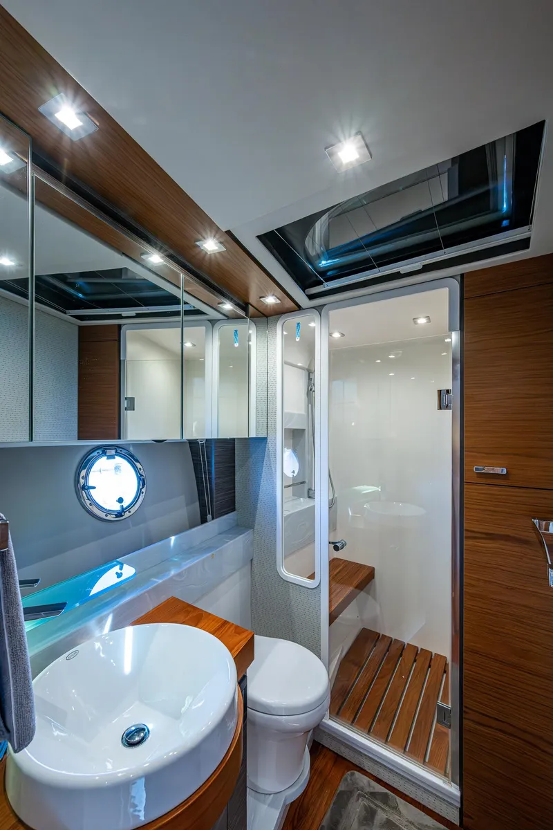 Slide: The Image of Luxurious bathroom in 2020 Tiara Yachts C53 Coupe with modern fixtures and wooden accents. - 29