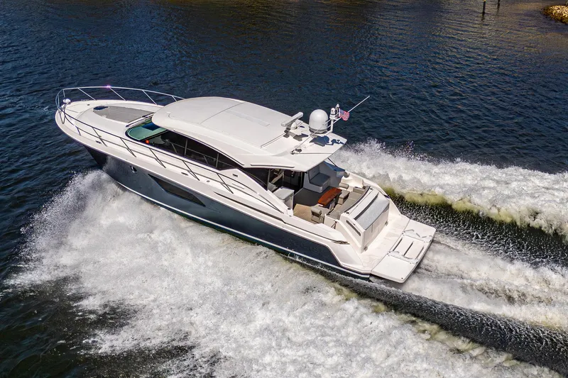 Slide: The Image of 2020 Tiara Yachts C53 Coupe cruising on water, aerial view. - 3
