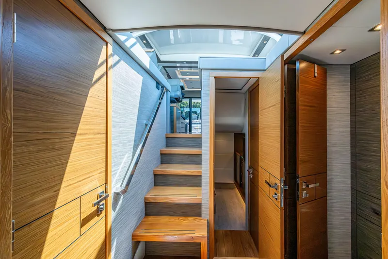 Slide: The Image of Interior of 2020 Tiara Yachts C53 Coupe with wooden stairs and modern design. - 30