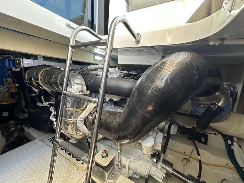 Slide: The Image of Engine compartment of 2020 Tiara Yachts C53 Coupe with visible ladder and exhaust system. - 37