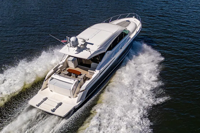 Slide: The Image of 2020 Tiara Yachts C53 Coupe cruising on open water, aerial view. - 4