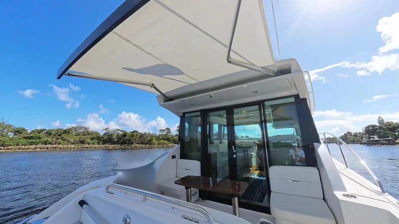 Slide: The Image of 2020 Tiara Yachts C53 Coupe on water, showcasing sleek design and spacious deck. - 6