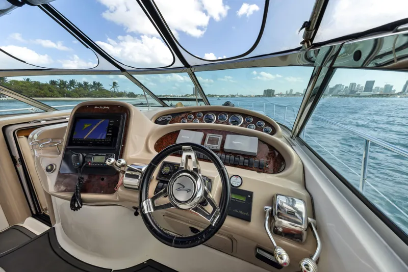 Slide: The Image of Cockpit view of 2003 Sea Ray 380 Sundancer yacht with city skyline in background. - 11