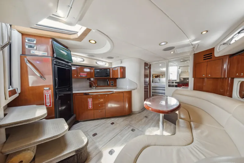 Slide: The Image of Luxurious interior of 2003 Sea Ray 380 Sundancer yacht with modern kitchen and seating area. - 13