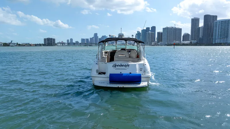 Slide: The Image of 2003 Sea Ray 380 Sundancer yacht on water with city skyline in background. - 31