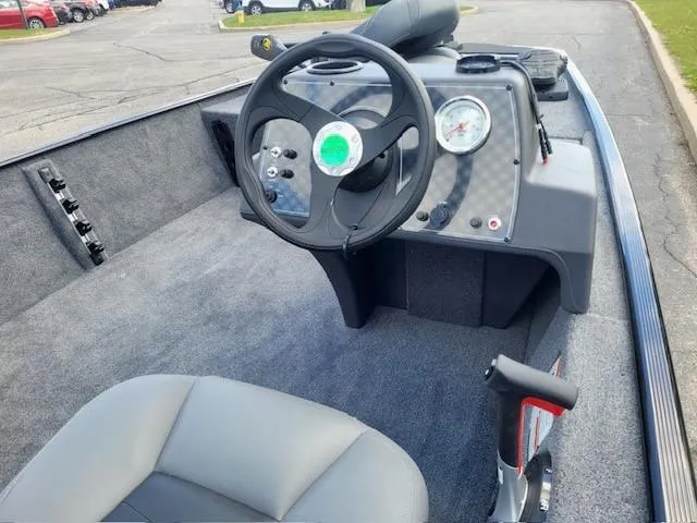 Slide: The Image of 2025 Tracker Bass Tracker Classic XL boat interior with steering wheel and dashboard. - 3